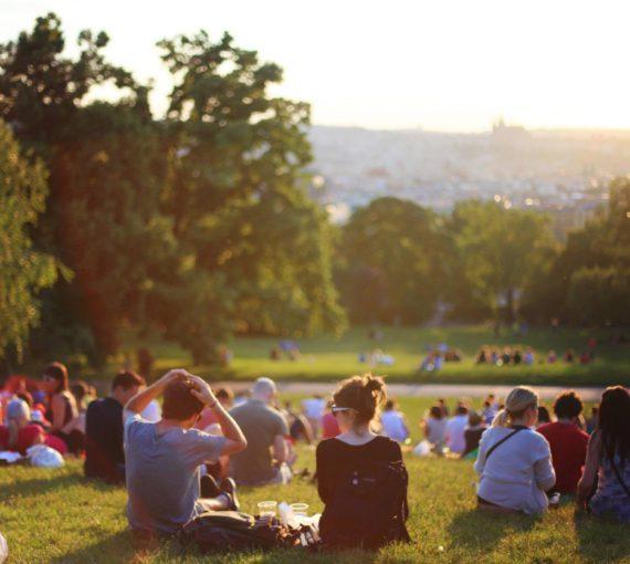 People sitting in the grass at a park
